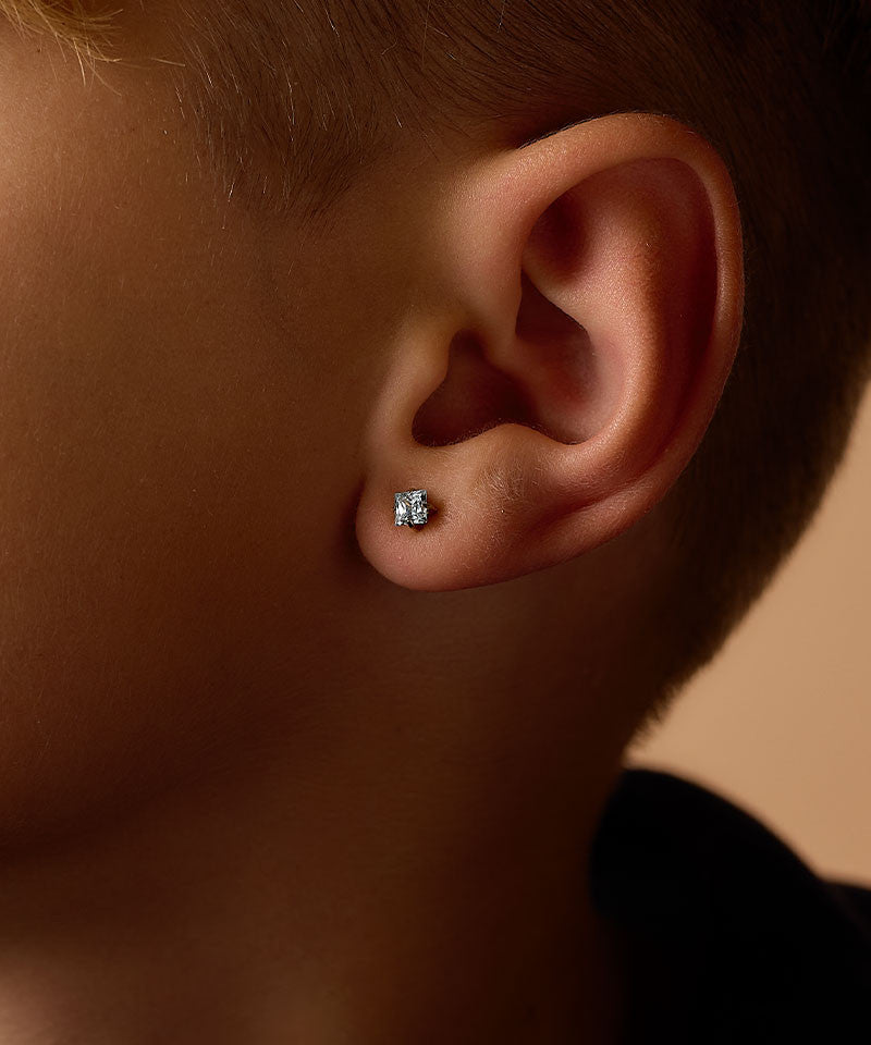 Model Wearing Golden Titanium 5mm Prong Set Edge Aquamarine CZ Earrings