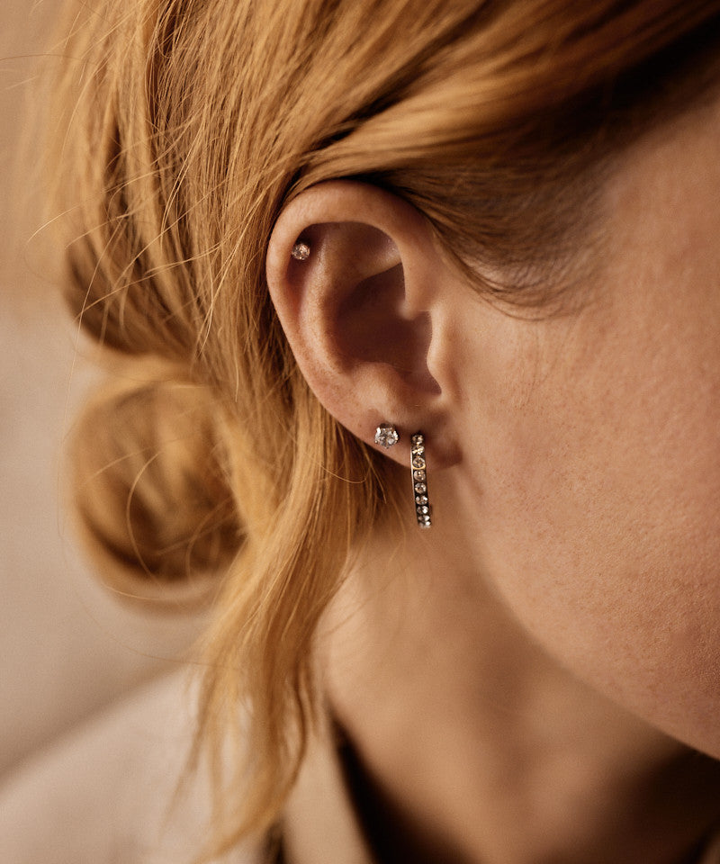 Model wearing Silver Titanium Prong Set Precious 5mm earrings
