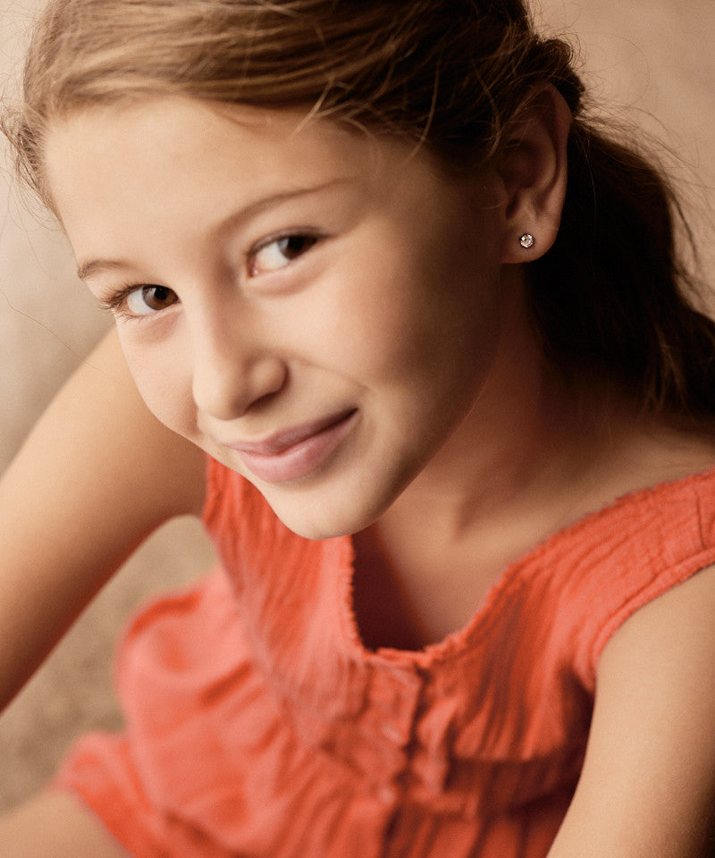 Model wearing Silver Titanium Prong Set Precious 5mm earrings