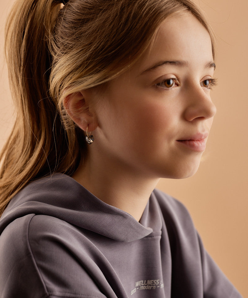 Model wearing Golden Titanium Black Diamond Heart Pendant earrings