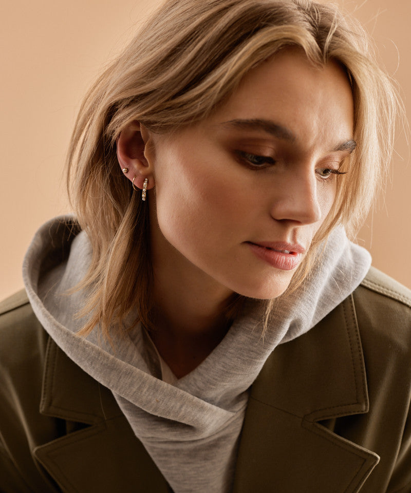 Model Wearing Hypoallergenic Golden Titanium 15mm Curved Pendant Crystal/White Pearl Earrings