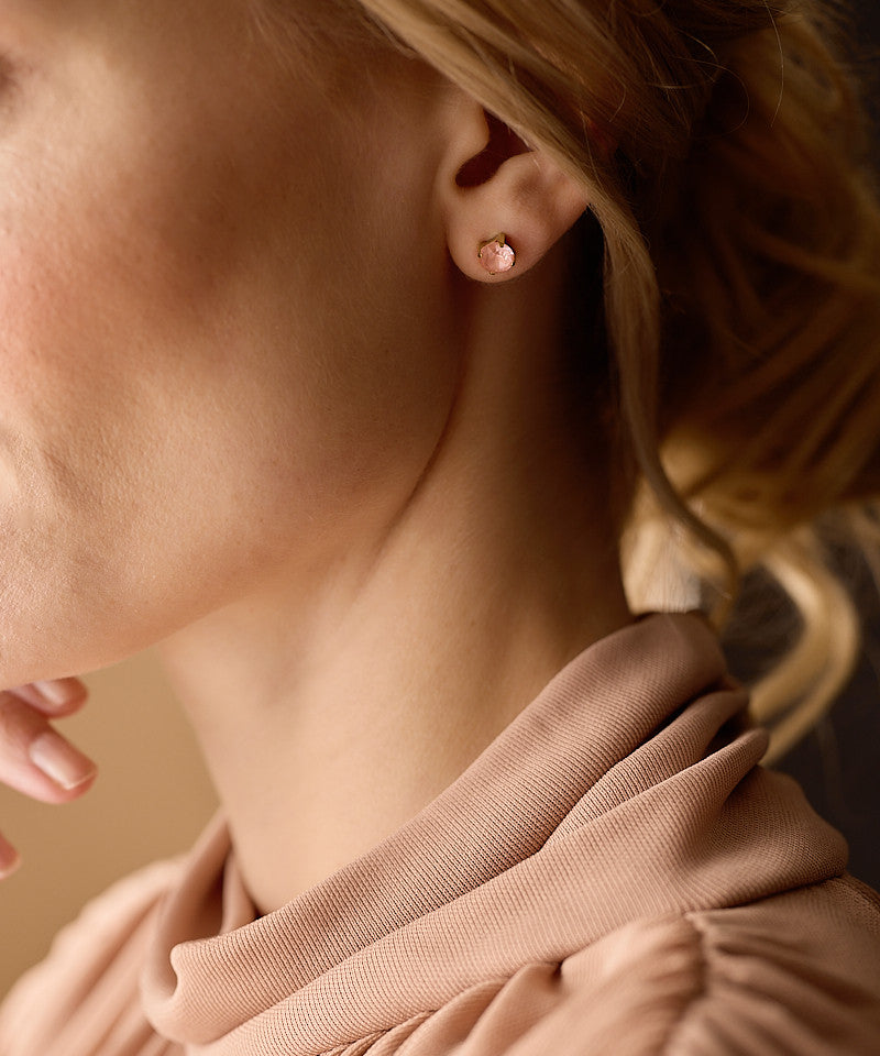 Model Wearing Golden Titanium 7mm Prong Set Coral Earrings