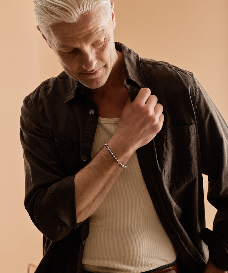Model wearing Globe Link Bracelet in silver