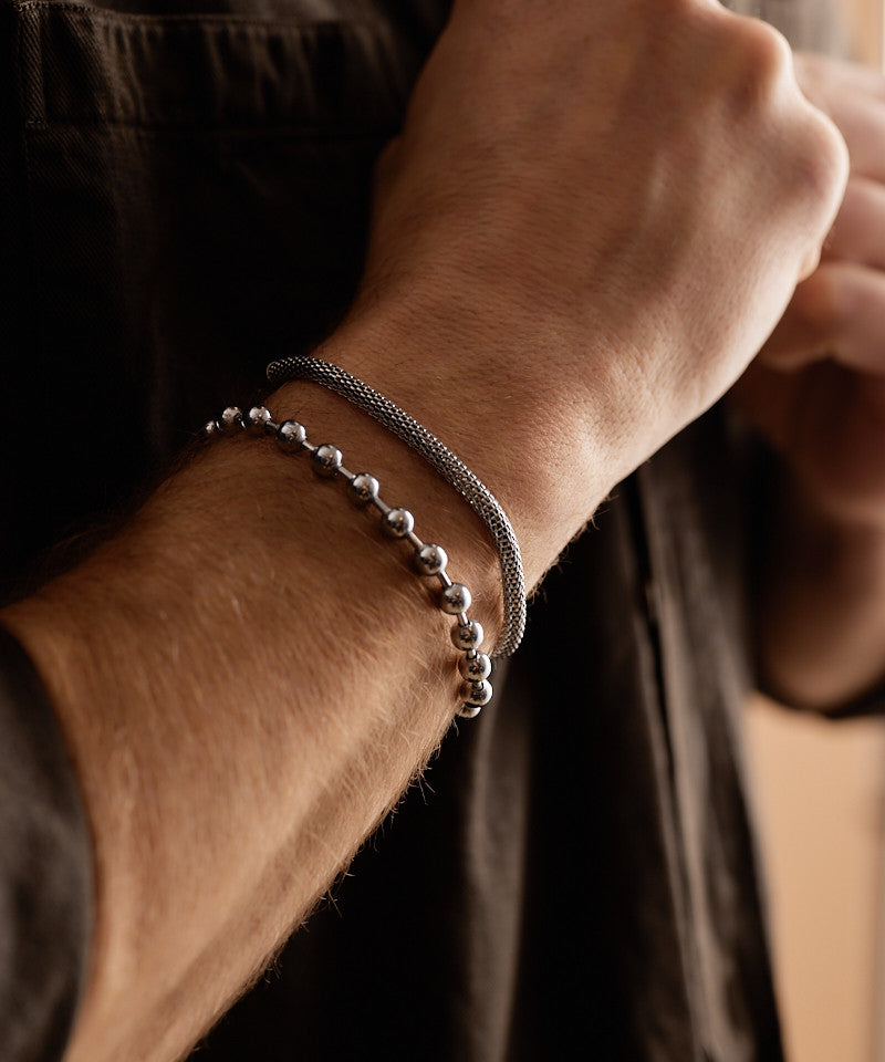 Model wearing Globe Link Bracelet in silver