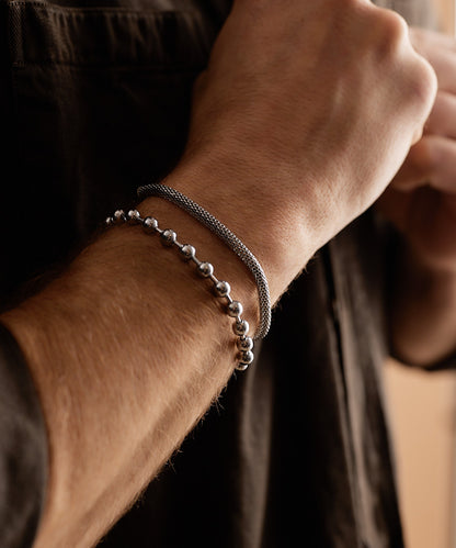 Model wearing Globe Link Bracelet in silver