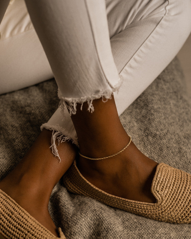 Skin safe twist anklet in gold on a model