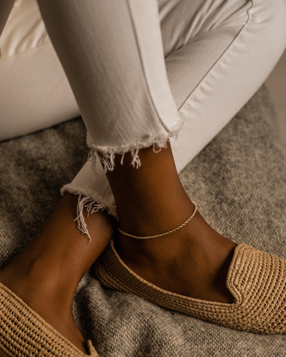 Skin safe twist anklet in gold on a model