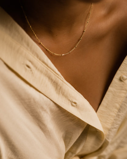 Ball necklace in gold on model